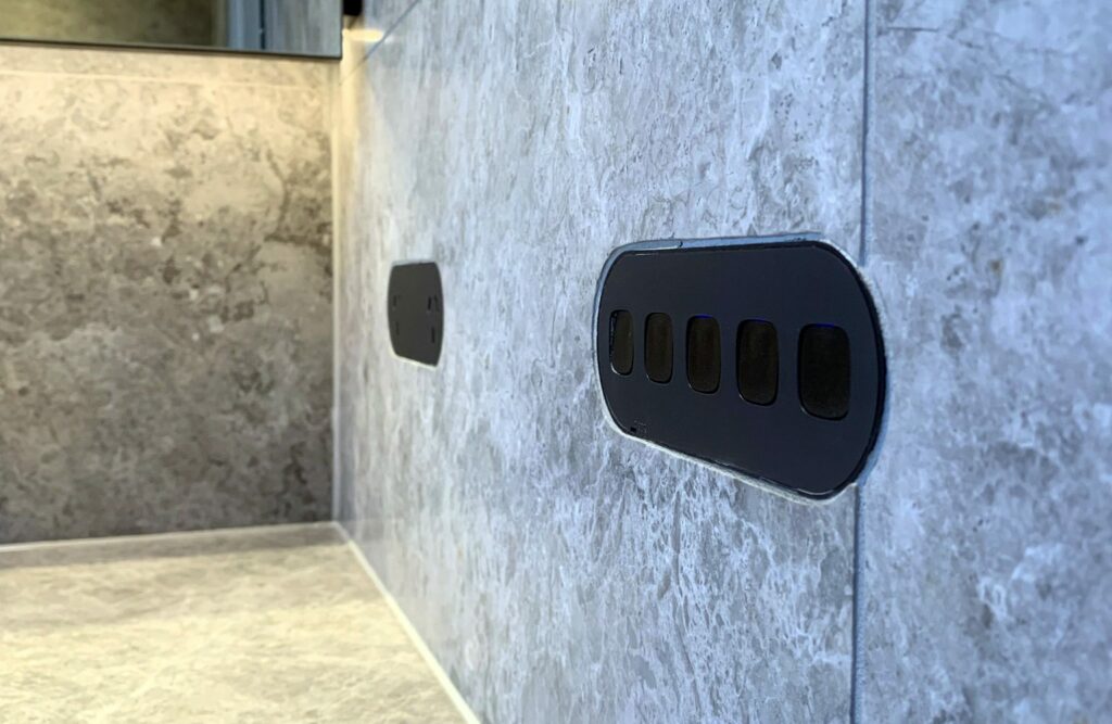ZETR black switch flush on bathroom tiles